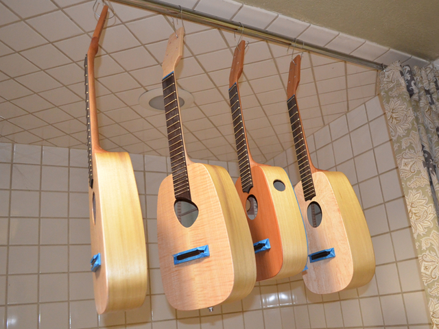 4 ukuleles getting their finish applied