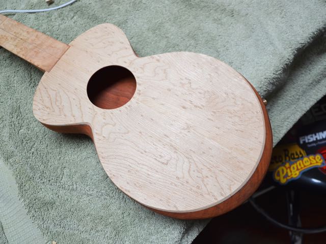 Soundboard is trimmed to the body. The lower bout appears round but actually extends slightly to create a comfortable angled armrest.